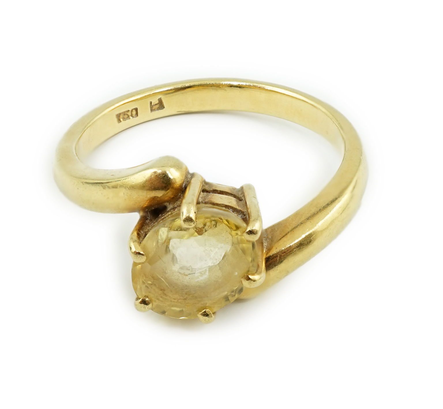 An 18k gold and solitaire oval cut yellow sapphire